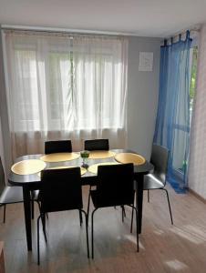 a dining room with a table and chairs and a window at Apartament Queen in Malbork