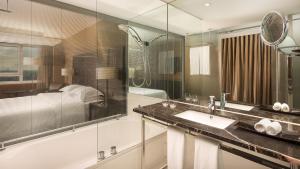 a bathroom with a sink and a shower at Sheraton Lisboa Hotel & Spa in Lisbon