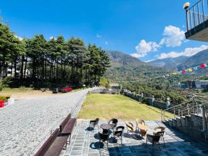 a group of chairs sitting on the side of a road at HOTEL DEVDAR RESORT in Dharmsala