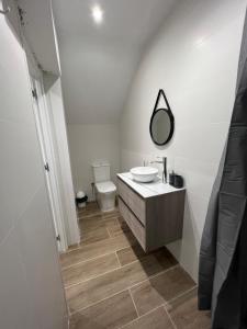 a white bathroom with a sink and a mirror at CASA DEL CASTILLO in Alicante