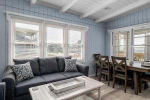 a living room with a couch and a table at Anchor Haven Ocean Views in Oak Island