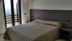 a bedroom with a large bed and a large window at Belsito in Serrone +48 photos