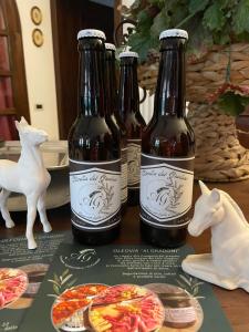three bottles of beer sitting on top of a table at Agriturismo Ai Gradoni in Teolo