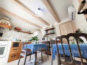 a kitchen with a table and chairs in a room at ROSSINI GUEST HOUSE in Martina Franca