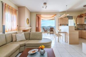 a living room with a couch and a kitchen at 2 Bedroom Cozy apartment with Sea View and balcony in Anavissos