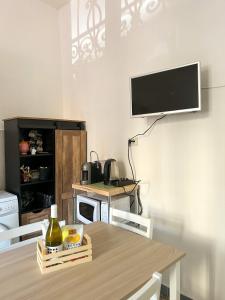 a dining room with a table and a tv on the wall at Trastevere’s Flower 