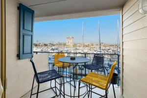 balcón con mesa y sillas y vistas al puerto en 208B Harbor View, Steps from the Beach, Free Wifi, en Oceanside