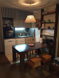a kitchen with a wooden table in a kitchen at Studio Le Fontagnel in Molines-en-Queyras