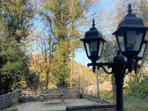 a street light next to a park with a bench at Bunkhouse@Glanrhyd in Pontardawe