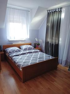 1 dormitorio con cama y ventana en Gospodarstwo Agroturystyczne Domek na Wzgórzu, en Chmielnik