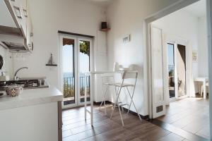 a kitchen with a table and chairs and a balcony at Villa Solaria in Sori