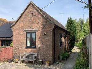 a brick house with a bench in front of it at The Old Exchange in Wimborne Minster