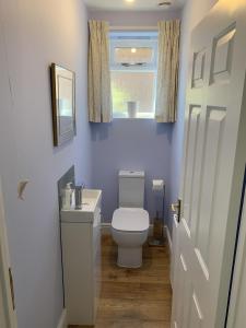 a bathroom with a white toilet and a window at The Old Exchange in Wimborne Minster