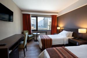 Postel nebo postele na pokoji v ubytování Hotel Crans Montana