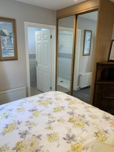 a bedroom with a bed with a floral bedspread at The Old Exchange in Wimborne Minster