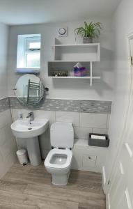 a bathroom with a white toilet and a sink at The Old Exchange in Wimborne Minster