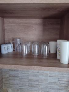 a row of glass jars sitting on a wooden shelf at Park veredas Rio Quente Flavia in Rio Quente