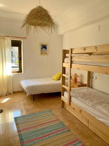 a bedroom with two bunk beds and a rug at casa loopez Hostel in Laredo