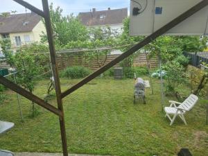 a view of a yard with two chairs and a swing at Ramstein Wohnung in Ramstein-Miesenbach