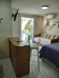 Ένα ή περισσότερα κρεβάτια σε δωμάτιο στο Perfeito Studio Praia