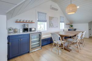 a kitchen with blue cabinets and a wooden table at Unique Scituate Vacation Rental on Herring River! in Scituate