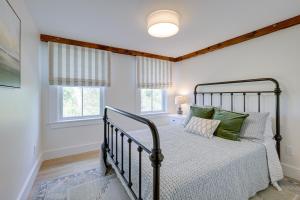 a bedroom with a bed and two windows at Unique Scituate Vacation Rental on Herring River! in Scituate