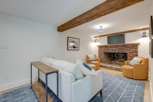 a living room with a couch and a fireplace at Unique Scituate Vacation Rental on Herring River! in Scituate