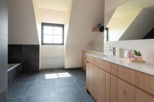 a bathroom with a sink and a bath tub at Country house - 'T Reigershof in Veurne +30 photos