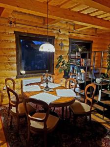 a dining room with a table and chairs at Zrubík pod Znievom (Log Cabin Zniev) 