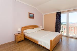 Postel nebo postele na pokoji v ubytování Angolo Apartments