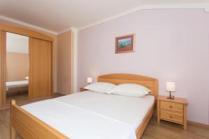 Postel nebo postele na pokoji v ubytování Angolo Apartments