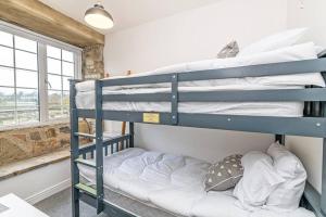 a bunk bed room with two bunk beds at Harestones - Bridge End Mill in Settle