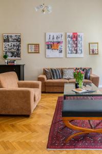 a living room with two couches and a table at SUPER CHIC with Balcony in Budapest