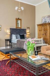 a living room with a coffee table and a bed at SUPER CHIC with Balcony in Budapest