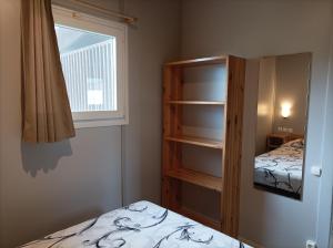 um pequeno quarto com uma cama e uma janela em La Masia BG parc em Sant Pere Pescador