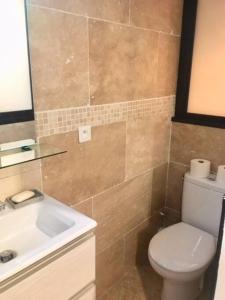 a bathroom with a toilet and a sink at Studio terrasse. A 50m de la plage Sablettes in Menton
