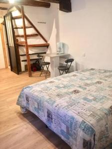 a bedroom with a bed and stairs in a room at Studio terrasse. A 50m de la plage Sablettes in Menton