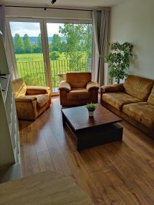 a living room with two couches and a coffee table at Mieszkanie przy Błoniach baza wypadowa na Rower in Rumia