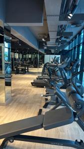 a gym with a row of treadmills in a room at Luxury 2 bedrooms 5 minutes from Burj Khalifa in Dubai