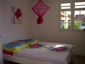 a bedroom with a bed with a kite on the wall at Villa Ducos in Ducos