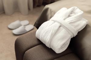 a white towel sitting on top of a couch at Boutique Hotel Saxonia in Karlovy Vary