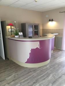 a kitchen with a purple and white counter top at Amadour Hôtel in Rocamadour