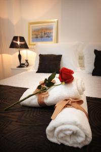 a bed with a white towel with a rose on it at Apartments Felicitas in Split