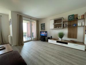 a living room with a couch and a television at Apartment 10 in Wilhelmshaven