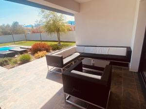 a patio with a couch and a swimming pool at Capella Suttana in Ventiseri
