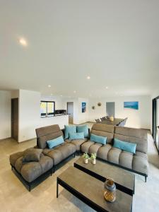 a living room with a large couch and a table at Capella Suttana in Ventiseri