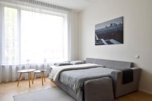 1 dormitorio con cama y ventana grande en Stylish Studio with Free Private Parking & Wi-Fi en Tallin