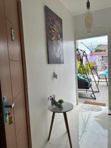 a room with a table and a painting on the wall at Residencial Napolitan in Manaus