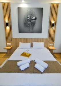a bedroom with a white bed with two pillows at Euro Hotel Kutaisi in Kutaisi