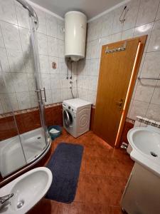 a bathroom with a toilet and a sink and a washing machine at Apartments Gojević in Crikvenica +10 photos